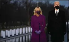  ?? ASSOCIATED PRESS ?? President-elect Joe Biden and Jill listen during a COVID-19 memorial, with lights placed around the Lincoln Memorial Reflecting Pool on Tuesday in Washington.