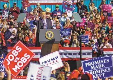  ?? Pat Sutphin Times-News ?? OPPOSITION to President Trump, shown in Elko, Nev., Saturday, is strong among college-educated women.