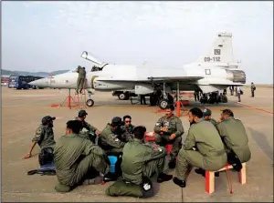  ?? AP/KIN CHEUNG ?? near a JF-17 jet fighter in this file photo taken at the 8th China Internatio­nal Aviation and Aerospace Exhibition in Zhuhai, China.