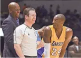  ?? JAKE ROTH/USA TODAY SPORTS ?? Lakers guard Kobe Bryant (24) and Nuggets head coach Brian Shaw, left, share a laugh with a referee during a game on Oct. 6, 2014, in San Diego.