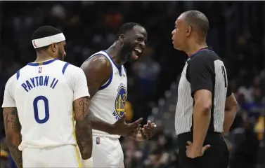  ?? NICK WASS — THE ASSOCIATED PRESS ?? Golden State Warriors forward Draymond Green, center, argues with referee Rodney Mott, right, after he was called for a personal foul and a technical foul during the second half of game against the Washington Wizards, March 27, in Washington. Warriors guard Gary Payton II (0) is at left. The Wizards won 123-115.