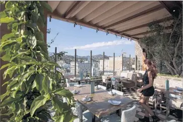  ?? Brian van der Brug Los Angeles Times ?? THE HIGHLIGHT restaurant on the roof of the Dream Hotel has commanding views of the hills. Room rates at the boutique Hollywood hotel, due to open soon, are expected to start at about $300 a night.