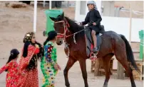  ?? Photos by M. Sajjad ?? A child enjoys horse ride during the Sharjah Spring Desert Festival at Al Batayeh area in Al Dhaid. —