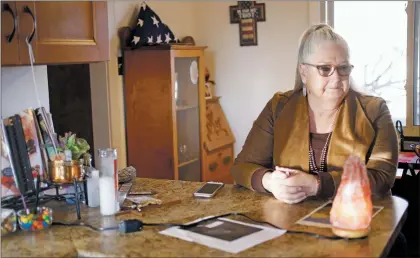  ?? Luis Sánchez Saturno/The New Mexican ?? Charlene Maes, the widow of Gilberto Ulibarri, has a quiet moment at her home. Maes is struggling to access federal benefits for her husband, who worked at Los Alamos National Laboratory and died from cancer.