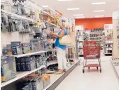  ?? JOE RAEDLE/GETTY ?? A customer shops Wednesday at a Target in Miami, Florida. The Minnesota-based retailer lost a quarter of its value following a weak earnings report.