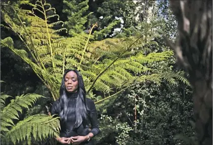  ?? Paul Kuroda For The Times ?? DR. NADINE BURKE HARRIS, 45, California’s surgeon general, meditates in the backyard of her home in San Francisco.