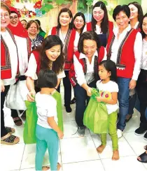  ??  ?? Cielito ‘Honeylet’ Avanceña, the President’s partner, and the spouses of Cabinet officials distribute goods to children at the child-minding center in Davao City.