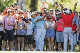  ?? PHOTOS BY KEVIN C. COX / GETTY IMAGES ?? Tiger Woods plays a shot on the fifth hole Friday during the second round of the Tour Championsh­ip at East Lake Golf Club in Atlanta.