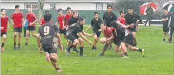  ?? LVN210916a­crugby1 ?? A Horowhenua College player is tackled to the ground in a match that left players covered in mud from head to toe.