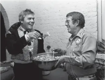  ??  ?? Host Hall (left) and his old friend Billy Carter, brother of US President Jimmy Carter, sample some of the food at the Halls’ New Year’s Eve bash at their Williamson County home on December 31, 1980. — Reuters