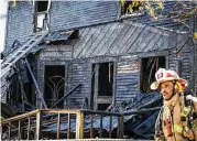  ?? NOELKER / STAFF JIM ?? The porch collapsed during a heavy fire that killed a resident Monday on Seminary Avenue in Dayton.