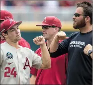  ?? NWA Democrat-Gazette/BEN GOFF ?? Arkansas center fielder Dominic Fletcher (left) fist-bumps strength and conditioni­ng coach Blaine Kinsley during team introducti­ons before the Razorbacks’ game against Texas on Sunday in the College World Series at TD Ameritrade Park in Omaha, Neb.