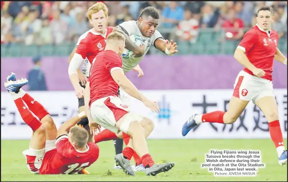  ?? Picture: JOVESA NAISUA ?? Flying Fijians wing Josua Tuisova breaks through the Welsh defence during their pool match at the Oita Stadium in Oita, Japan last week.