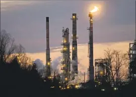  ?? Gerald Herbert Associated Press ?? EXXON MOBIL, Chevron and Total aren’t expected to cut their dividends despite the industry’s troubles. Above, the Exxon refinery in St. Bernard Parish, La.