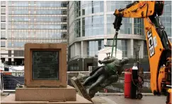  ??  ?? A STATUE of Robert Milligan, an 18th century slave trader, is removed by workers outside the Museum of London Docklands in the UK. | REUTERS