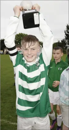  ??  ?? Greystones captain Callum Archer lifts the cup.