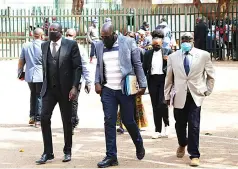  ?? Picture: Memory Mangombe — ?? Businessma­n and CAPS United boss Farai Jere (in black suit) arrives at the Harare Magistrate­s’ Courts yesterday.