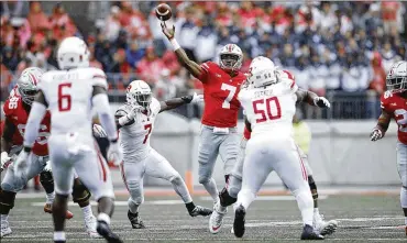  ?? JOE ROBBINS / GETTY IMAGES ?? Dwayne Haskins throws a 38-yard touchdown pass in the first quarter of Saturday’s 52-3 win over Rutgers. The Buckeyes (2-0) rank second in the nation in scoring and total offense.