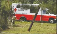  ??  ?? The remains of a 2018 Ford F-150 (left) crushed by a fallen tree in the yard of Karl and Kim Nichols is part of property damage the family sustained during the storm. Right, An American Red Cross Disaster Relief truck travels throughout the Faircrest...