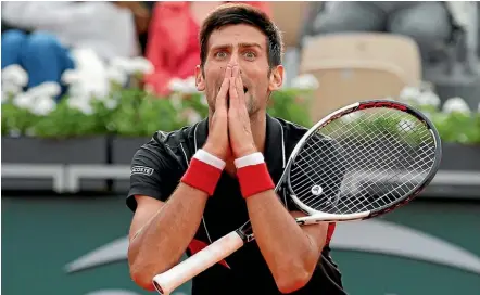  ?? AP, GETTY IMAGES ?? Novak Djokovic cannot believe he missed an easy point during his French Open quarterfin­al loss to Italian Marco Cecchinato, who celebrated his shock win by dropping onto the clay court in disbelief.