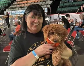  ?? Jackie Armour ?? Jackie Armour, Paws Across Pittsburgh’s founder and president, poses with Gertie at “Puppy Bowl XX.”