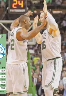  ?? STaff phoTos By sTUaRT CahILL ?? FINISHING TOUCH: Marcus Morris (left) fires up the crowd after hitting a 3-pointer and getting fouled, and Al Horford (left) gets a high-five from Aron Baynes near the end of the Celtics’ 112-96 victory against the Milwaukee Bucks in Game 7 last night...