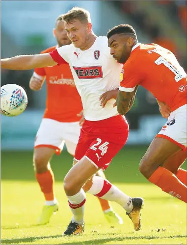  ??  ?? DUEL: Blackpool’s James Husband and Rotherham’s Michael Smith battle for the ball