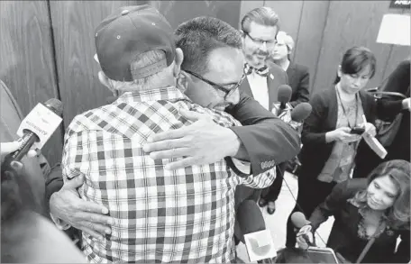  ?? Al Seib Los Angeles Times ?? MARCO CONTRERAS, center, hugs his father, Donato Contreras. Marco credits being a Jehovah’s Witness for keeping depression at bay.