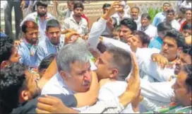  ?? HT PHOTO ?? State Congress Kisan Cell president Sandeep Choudhary being manhandled by supporters of a local leader at Shahpura on Friday.