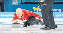  ?? AP PHOTO/NATACHA PISARENKO ?? Canada’s skip Kevin Koe throws a rock during a men’s curling match against Italy at the 2018 Winter Olympics in Gangneung, South Korea, Wednesday.
