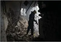  ?? BERNAT ARMANGUE THE ASSOCIATED PRESS ?? A Ukrainian firefighte­r works inside a destroyed cultural center in Derhachi, eastern Ukraine, on Sunday. A Russian airstrike destroyed the venue on Thursday.