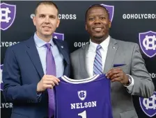  ?? PHOTO COURTESY OF HOLY CROSS ?? NO. 1 CHOICE: New Holy Cross men’s basketball coach Brett Nelson (left) poses with athletic director Marcus Blossom yesterday.