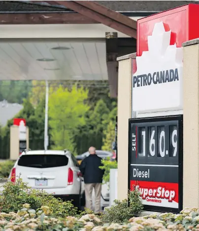  ?? RICHARD LAM/PNG ?? A motorist fills up his car Monday at $160.9 a litre (if he’s buying regular) in Surrey. Vancouver’s gas prices are highest in the country.