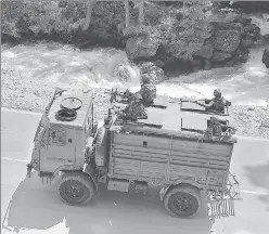  ??  ?? Army personnel on the Srinagar-Ladakh highway at Gagangeer in Srinagar on Wednesday.