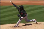  ?? MATT YORK — THE ASSOCIATED PRESS ?? Giants starting pitcher Johnny Cueto throws against the Angels during the first inning of their spring game on Thursday in Tempe, Ariz.