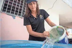  ??  ?? Michelle Rebollo still collects rainwater, having gone without running water for weeks. Service is back, but only a few hours a day. PHOTOS BY JASPER COLT/ USA TODAY