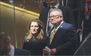  ?? CP PHOTO ?? Canada’s Minister of Public Safety Ralph Goodale and Canadian Minister of Foreign Affairs Chrystia Freeland make their way to a press briefing in Toronto on Monday.