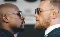  ?? Associated Press ?? n Floyd Mayweather Jr., and Conor McGregor face off at a press conference Aug. 23.