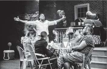  ?? Photograph­s by Jeff Lorch ?? THE MURDEROUS Rev (Billy Eugene Jones) pontificat­es at a family barbecue in James Ijames’ “Fat Ham.”