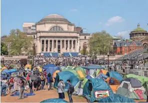  ?? SPENCER PLATT/ GETTY IMAGES ?? Israel-hamas war protesters remain in an encampment on the campus of Columbia University on April 29 in New York City. Columbia University issued a notice to the protesters asking them to disband their encampment after negotiatio­ns failed to come to a resolution.