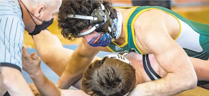  ?? APRIL GAMIZ/THE MORNING CALL ?? Allentown Central Catholic’s George Psarros, top wrestles Mahanoy Area’s Cael Quick in a 189 lbs. match during the quarterfin­als of the District 11 2A wrestling tournament at Charles Chrin Community Center of Palmer Township.