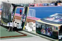  ?? AP ?? Ronaldinho in Pakistan and (right) Pakistani workers install advertisin­g boards featuring Ronaldinho, Ryan Giggs and other visiting stars in Karachi. —