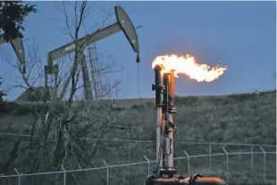  ?? MATTHEW BROWN/ASSOCIATED PRESS ?? A flare burns in 2021 at a well pad near Watford City, N.D. American oil and natural gas wells, pipelines and compressor­s are spewing three times the amount of the potent heat-trapping gas methane as the government thinks, a new comprehens­ive study calculates.