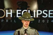  ?? JIM NOELKER PHOTOS / STAFF ?? Sgt. Tyler Ross talks about road saftey during the eclipse. “If you miss it, you miss it,” Ross said. “I know it’s a rare event, but it’s not worth your life.”