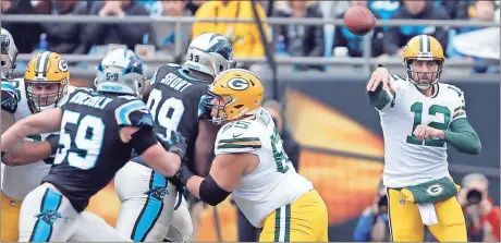  ?? Bob Leverone / AP ?? Green Bay quarterbac­k Aaron Rodgers (right) throws a pass against the Carolina Panthers during the first half of Sunday’s game in Charlotte, N.C.