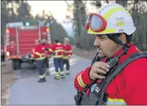  ?? AP PHOTO ?? Hugo Simoes talks on the radio while co-ordinating a group of volunteer firefighte­rs from Lisbon helping fight a forest fire Aug. 10 near the village of Aldeia do Monte outside Abrantes, central Portugal.