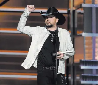  ?? Chris Pizzello ?? The Associated Press Jason Aldean accepts the award for Entertaine­r of the Year at the 53rd annual Academy of Country Music Awards on Sunday at the MGM Grand Garden Arena. Aldean paid tribute to the victims of the Oct. 1 shooting and their loved ones.