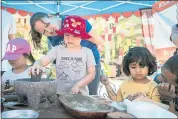  ?? LIPO CHING — STAFF PHOTOGRAPH­ER ?? Garrett Paymer, 4, center left, and Amara Bafna, 2, center right, make “food” with playdough as their parents Rajesh Bafna, right, and Silja Paymer left, watch at the Children’s Discovery Museum on Saturday.