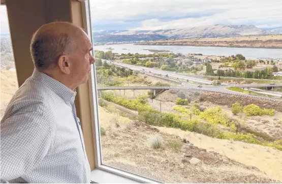  ?? ANDREW SELSKY/AP ?? Mayor Richard Mays gazes Oct. 5 at the Columbia River from his home in The Dalles, Oregon. Mays helped negotiate a proposal by Google to build new data centers in the town, but they require a lot of water to cool their servers. River water would not be used.