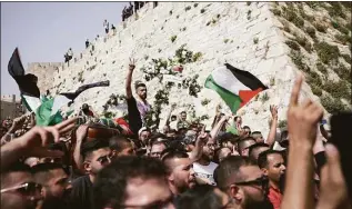  ?? Ariel Schalit / Associated Press ?? Mourners carry slain Al Jazeera veteran journalist Shireen Abu Akleh’s casket from her funeral in the Old City of Jerusalem to the cemetery on Friday.